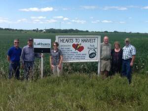 All proceeds from crops raised on a 40-acre plot by Hearts for Harvest go to help poverty-stricken families in third world countries. Pictured from left to right are board members: Scott Rochau, Bob Braden; Shannon Latham, Latham Hi-Tech Seeds; Dave Boeding, Nancy Urmie & Dan Urmie.