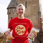 Garrett Ley with two of his favorite flavored popcorn products. 