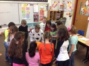 Second grade students conduct a sink/float experiment with pumpkins when Mrs. Symens teaches Science in the fall.